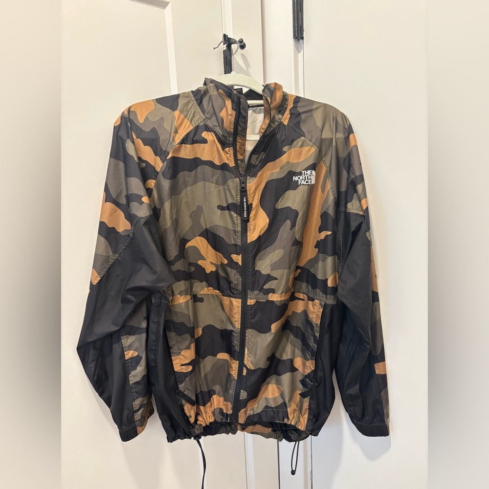 The North Face NSE Graphic Wind Jacket featuring a camouflage pattern